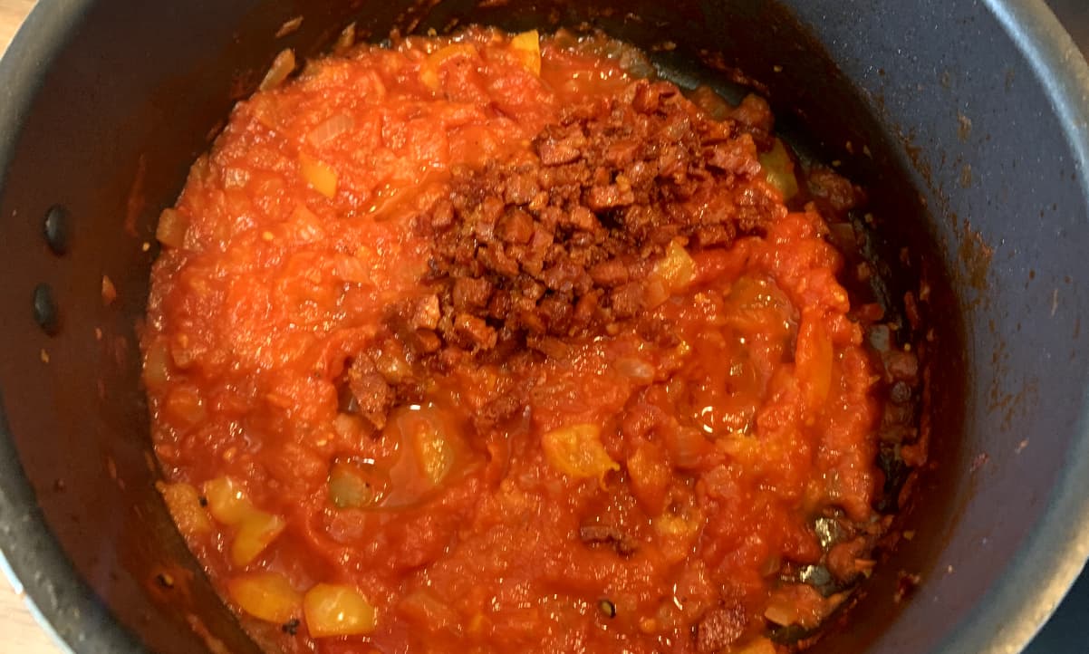 chorizo tossed on top of red pasta sauce