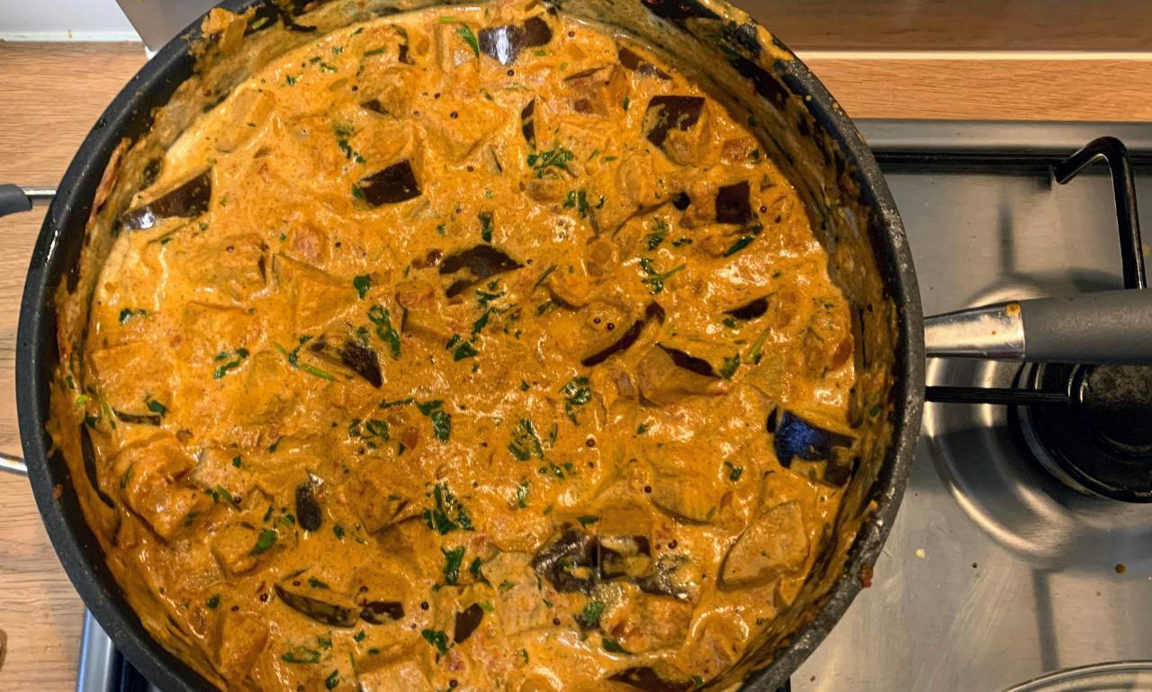 creamy aubergine curry cooking in a pan