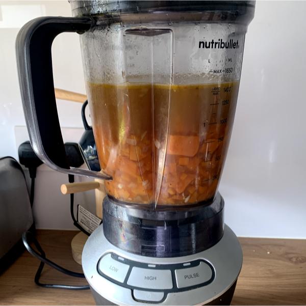 a blender filled with unblended carrot and sweet potato soup