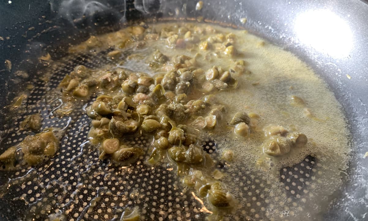 capers in lemon juice in a pan