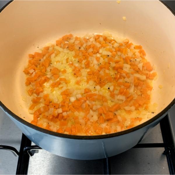 diced carrots and onion cooking in a pot