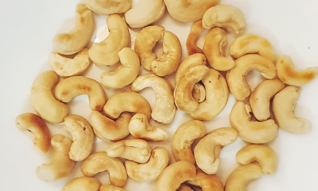 cashews arranged together on a white table