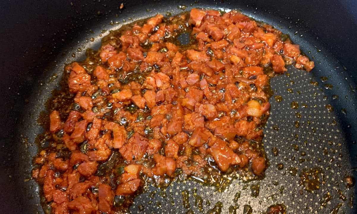 finely diced chorizo frying in its own oil in a pan