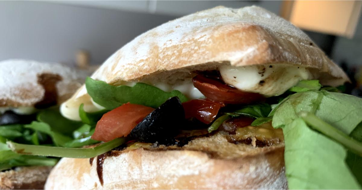 bruschetta sandwiches filled with mozzarella, tomatoes, rocket and black olives