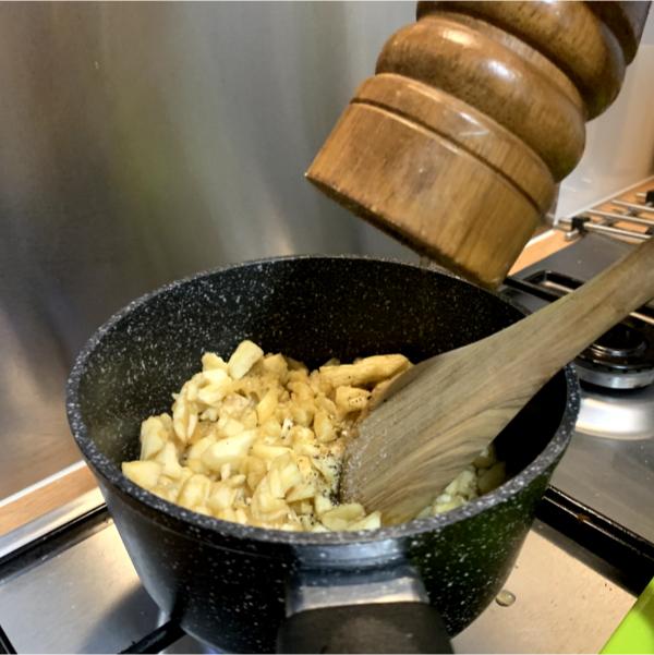 diced raw aubergine cooking in a small pot