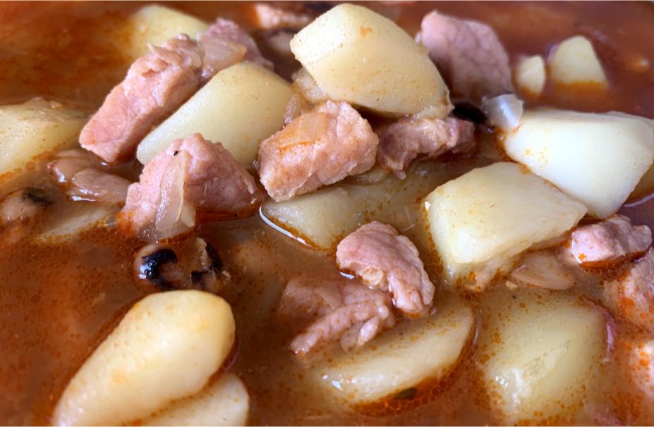 a closeup of meat, potato and black-eyed bean soup