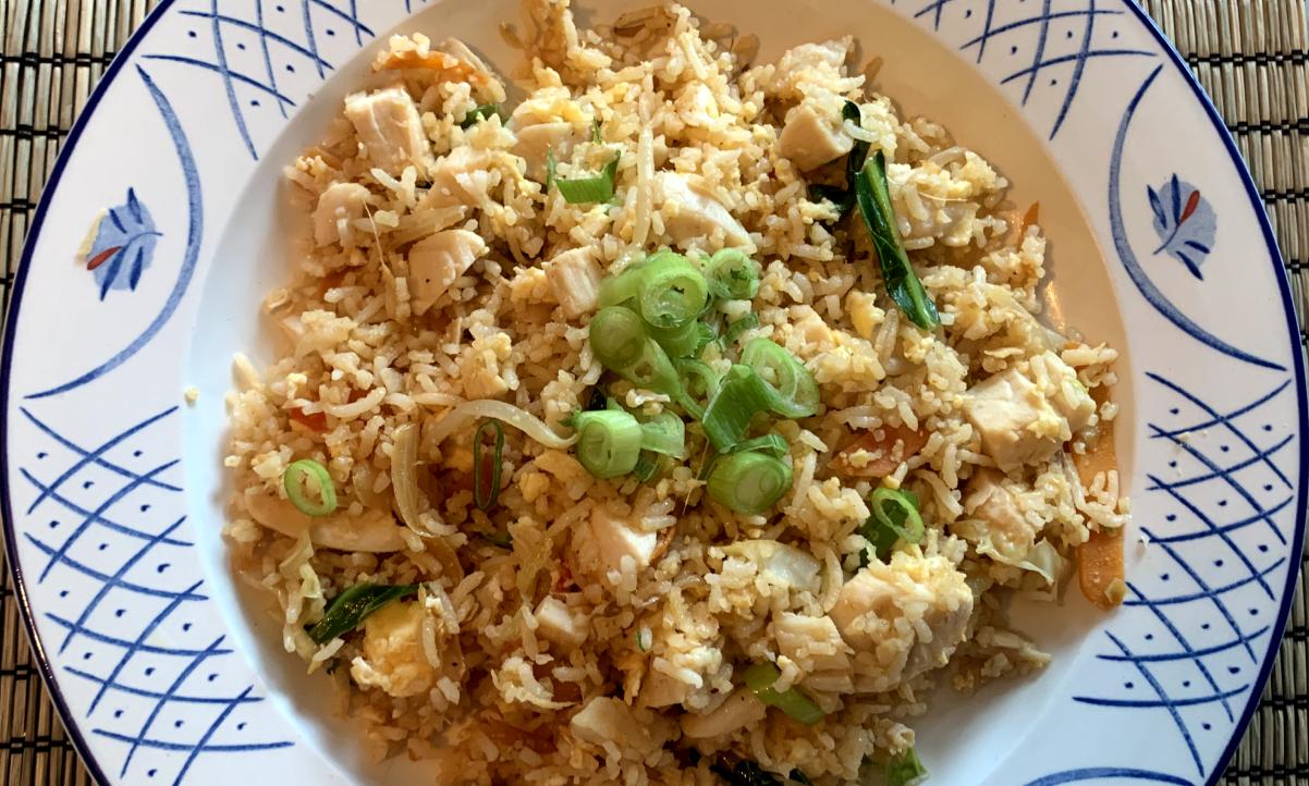 chicken fried rice with basmati on a blue and white place, photographed from above