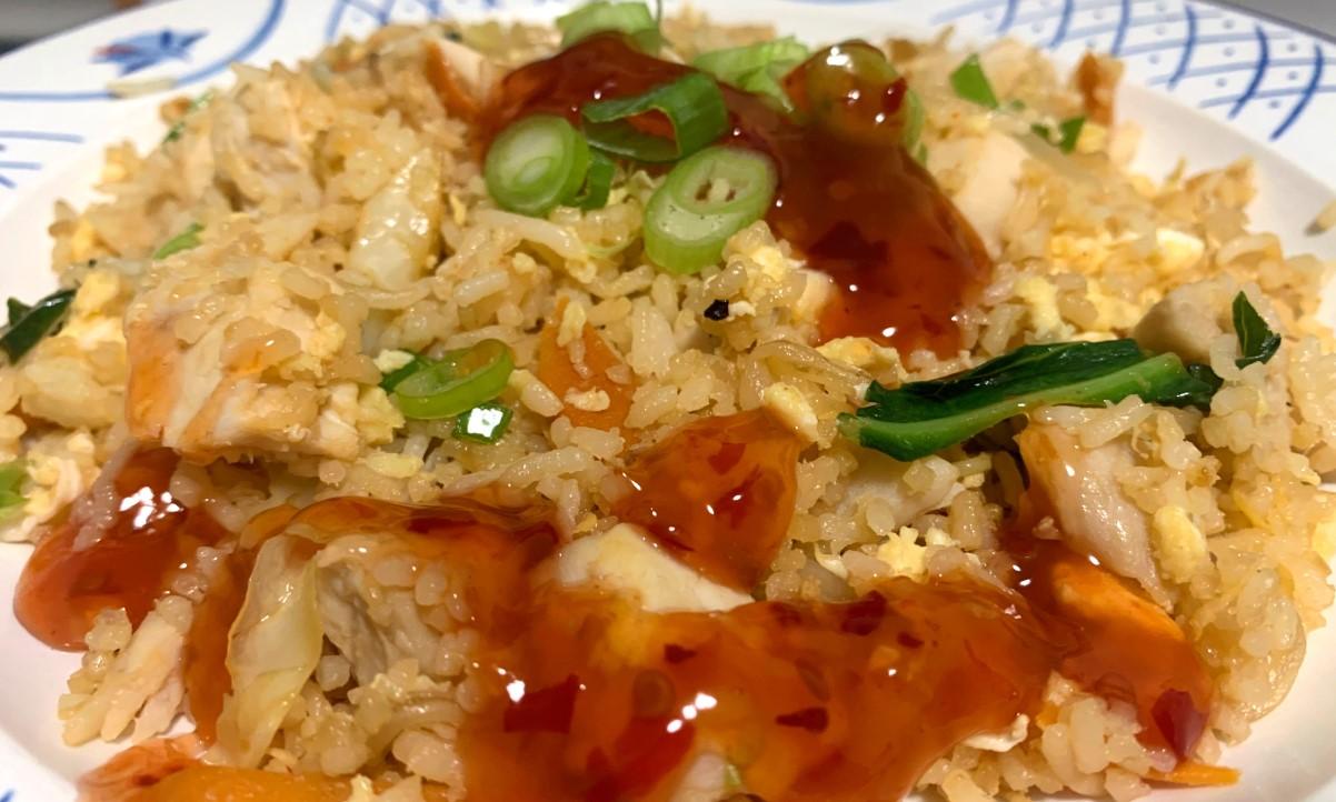 closeup of chicken fried rice and sweet chilli sauce