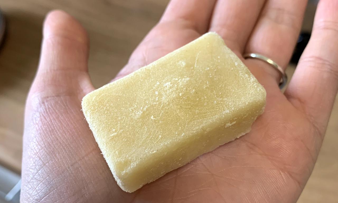 a palm-sized, pale yellow block of frozen ginger