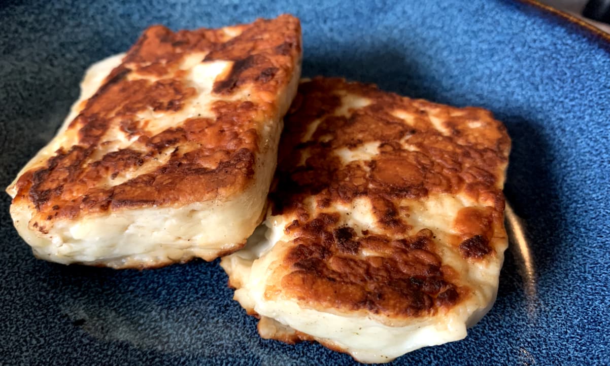 golden fried halloumi slices in a blue bowl