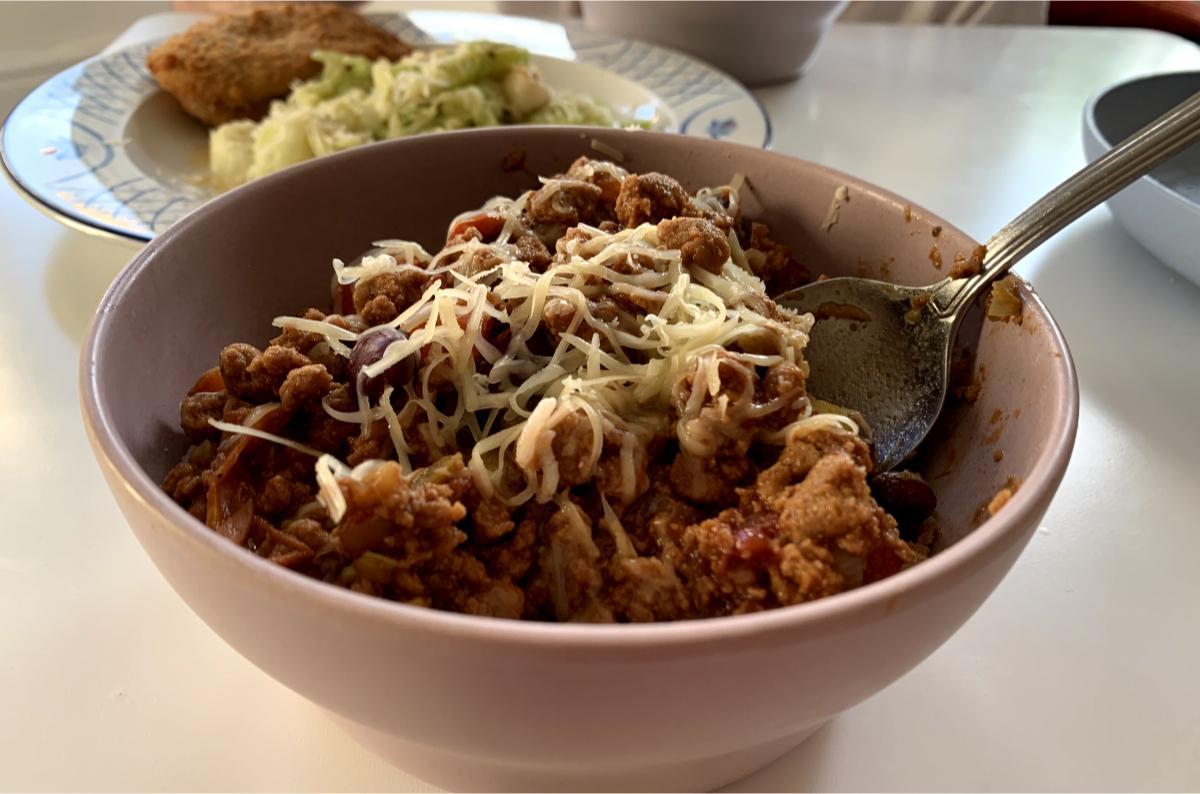 A bowl of Quorn chilli garnished with grated cheese