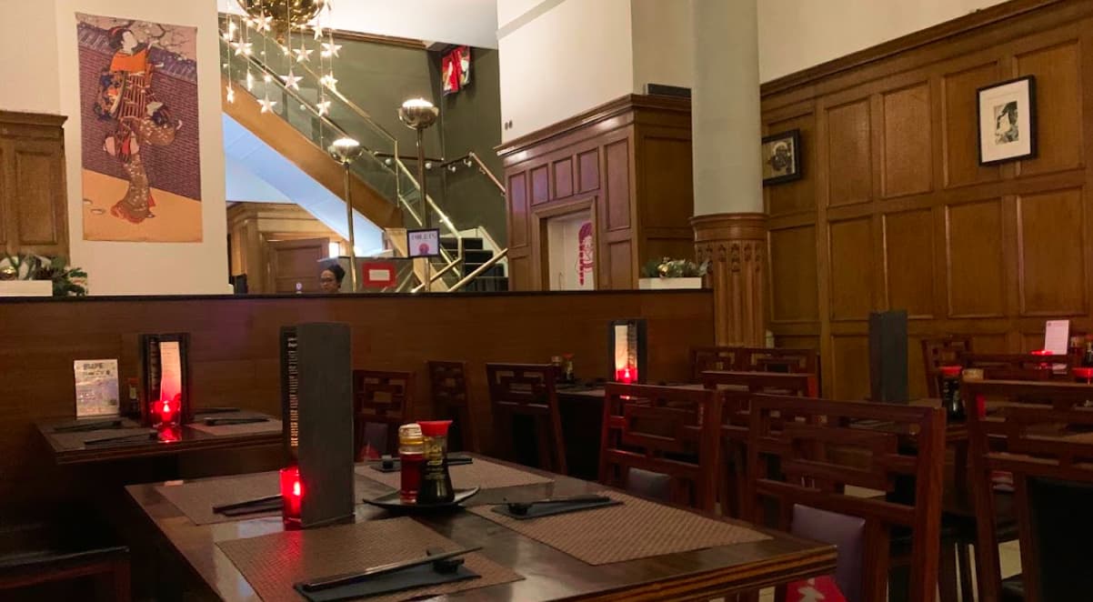 the interior of Nippon Kitchen, a Japanese restaurant adorned with wood panelled walls and japanese art