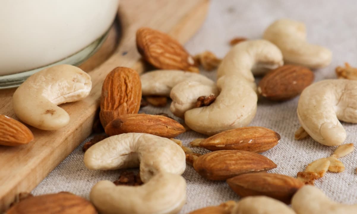 cashews and almonds arranged together on a table 