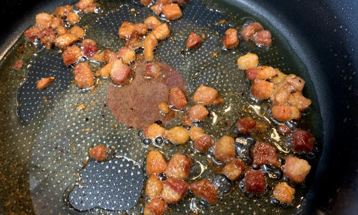 smoked pancetta frying in olive oil, getting crispy