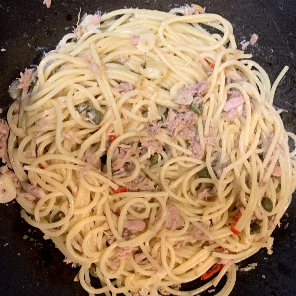 spaghetti with tuna and chilli cooking in a pan