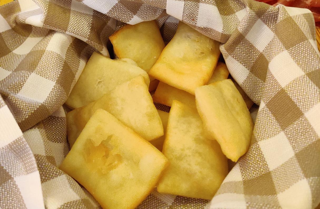 fresh pinzini sitting in a cloth-lined bowl