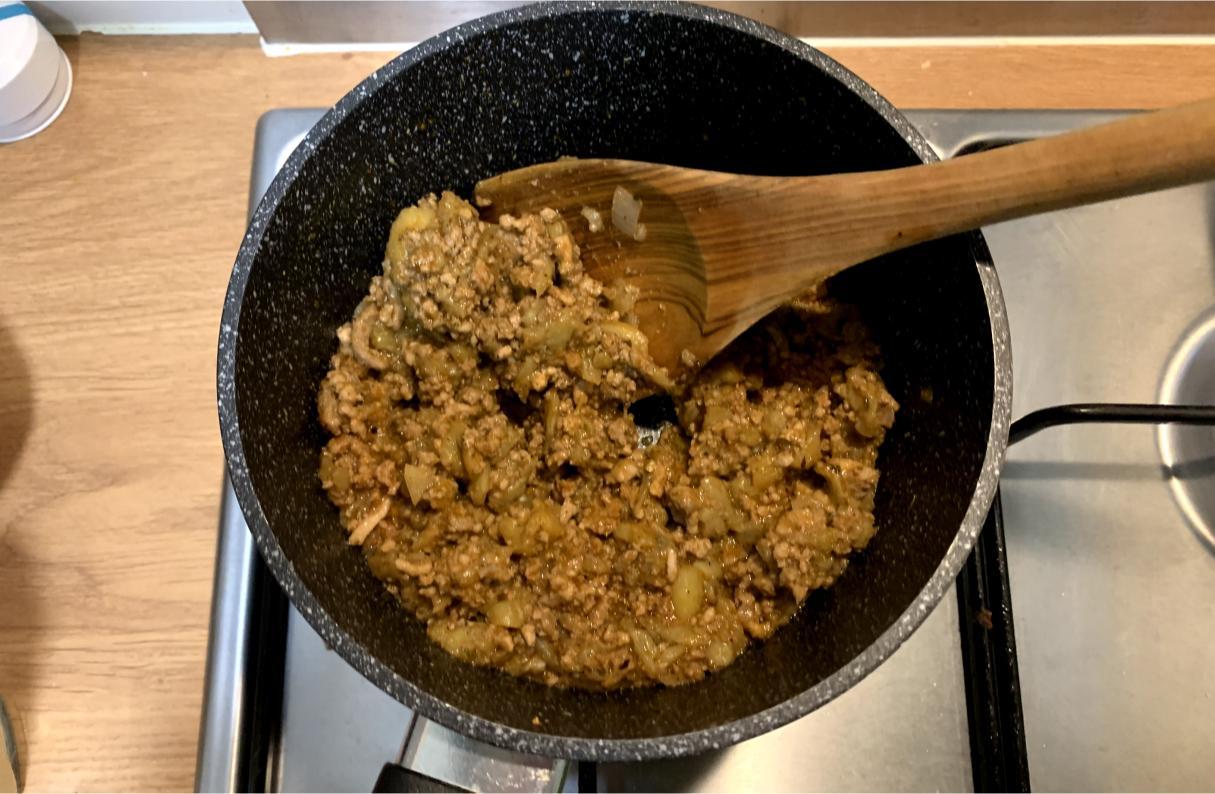 ragù and aubergine cooking in a small pot