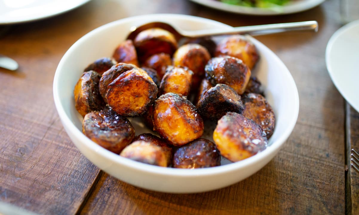 roast potatoes garnished with sea salt in a bowl