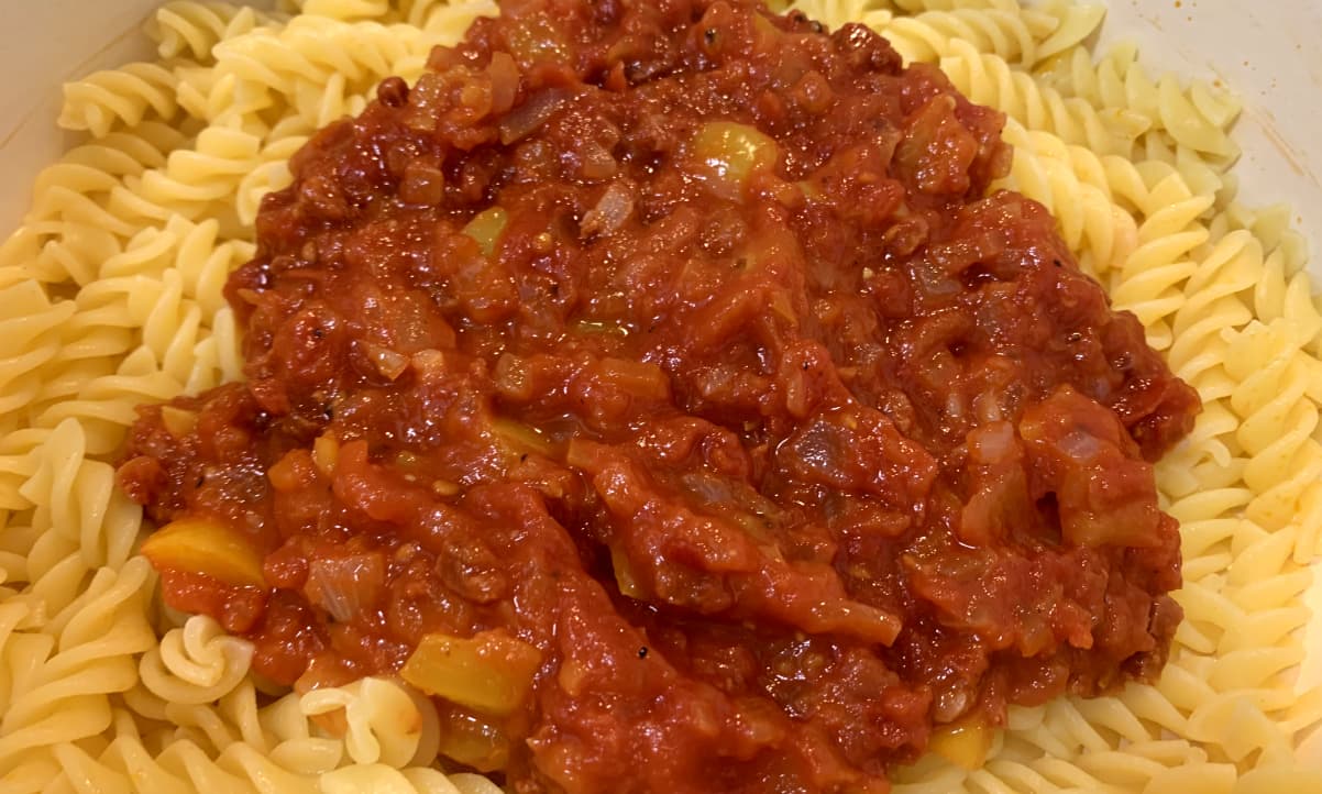 chorizo and yellow pepper pasta sauce in a black pot