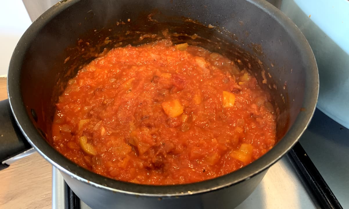 red pasta sauce with chunks of yellow pepper