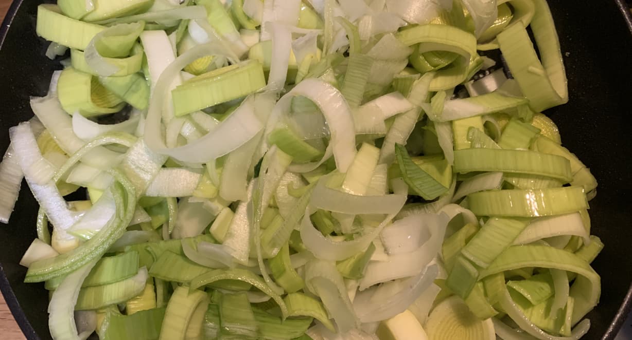 raw leeks on a black background