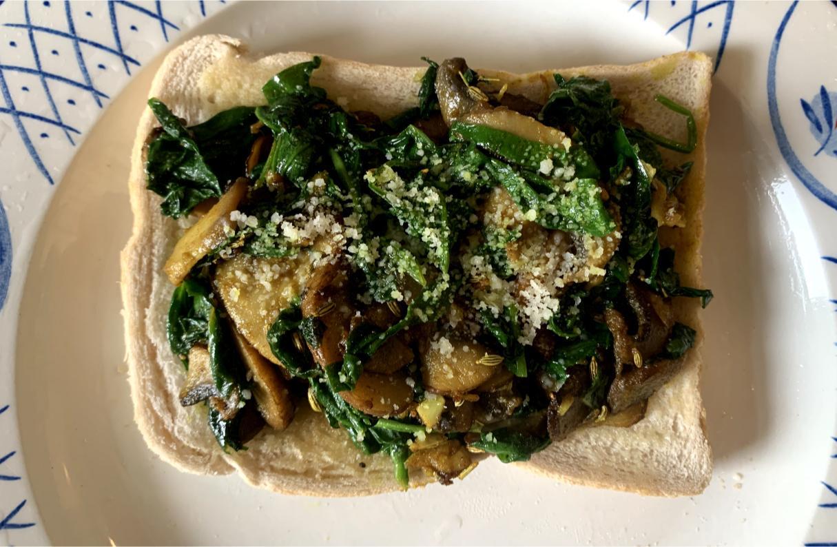 spinach and mushroom toast dusted with pecorino