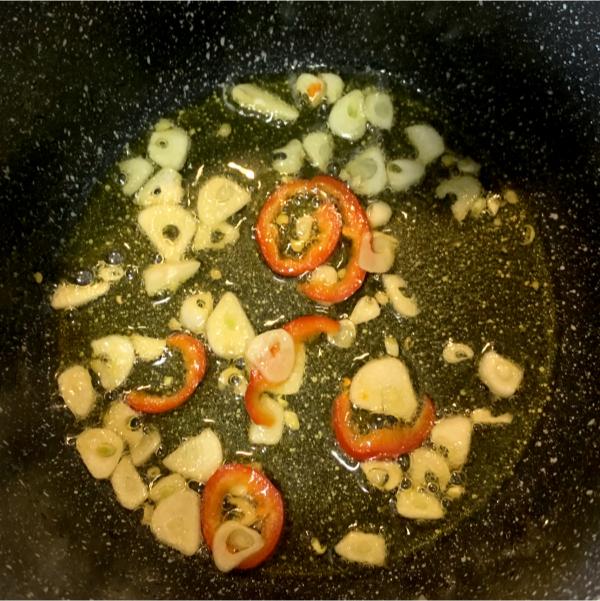 sliced garlic and chilli frying in a small pan