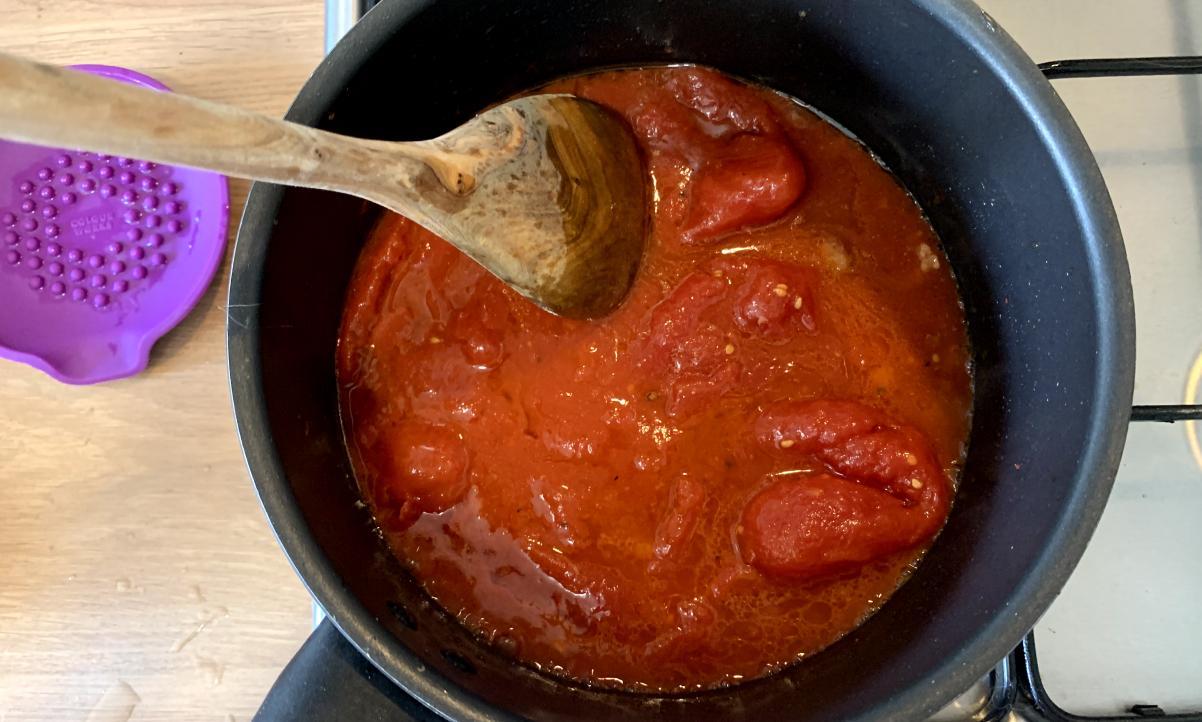 peeled plum tomatoes and water in a pan