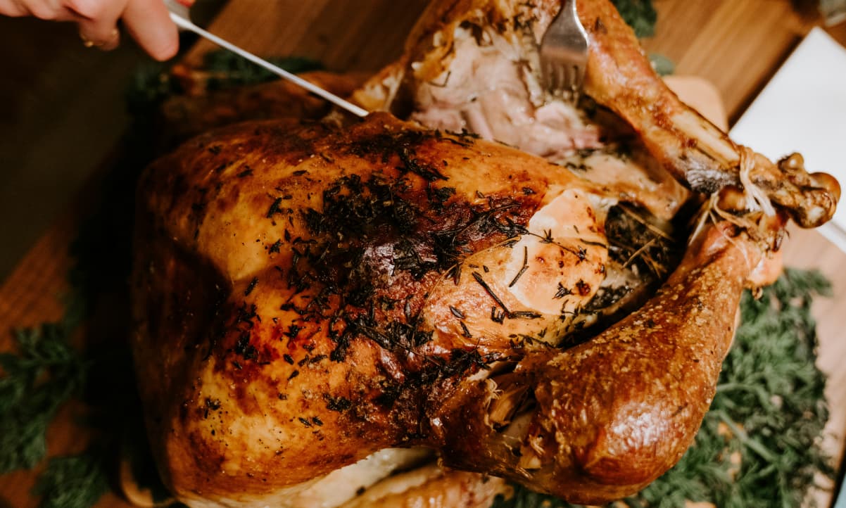 a roasted turkey, golden brown and garnished with sprigs of thyme