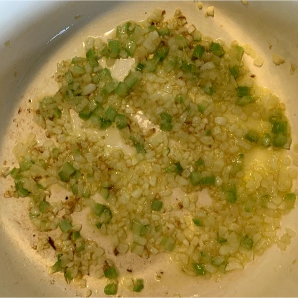 onions and celery frying in a pan